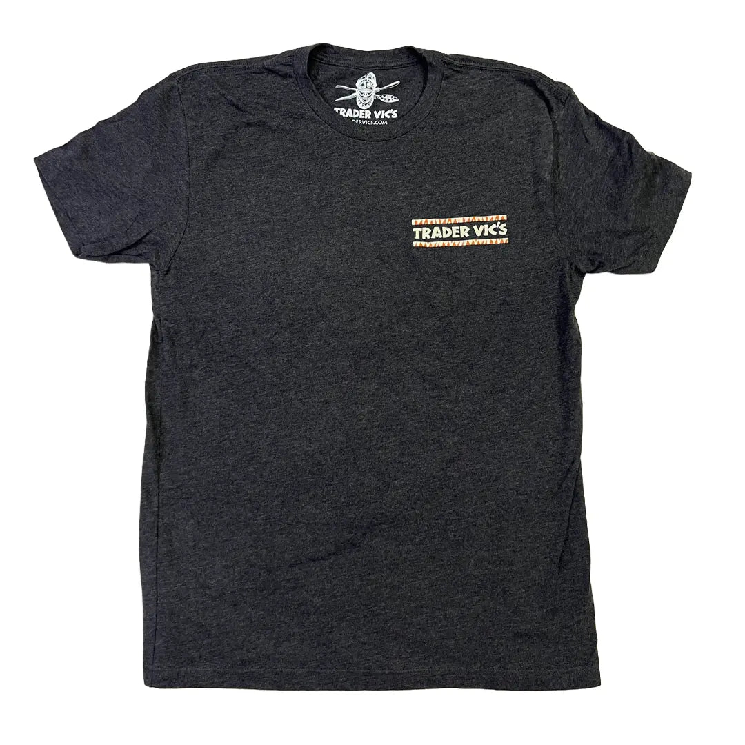 A dark heather gray crewneck t-shirt with a small orange and white graphic on the left chest reading 'TRADER VICS'. The shirt is laid flat against a solid white background.