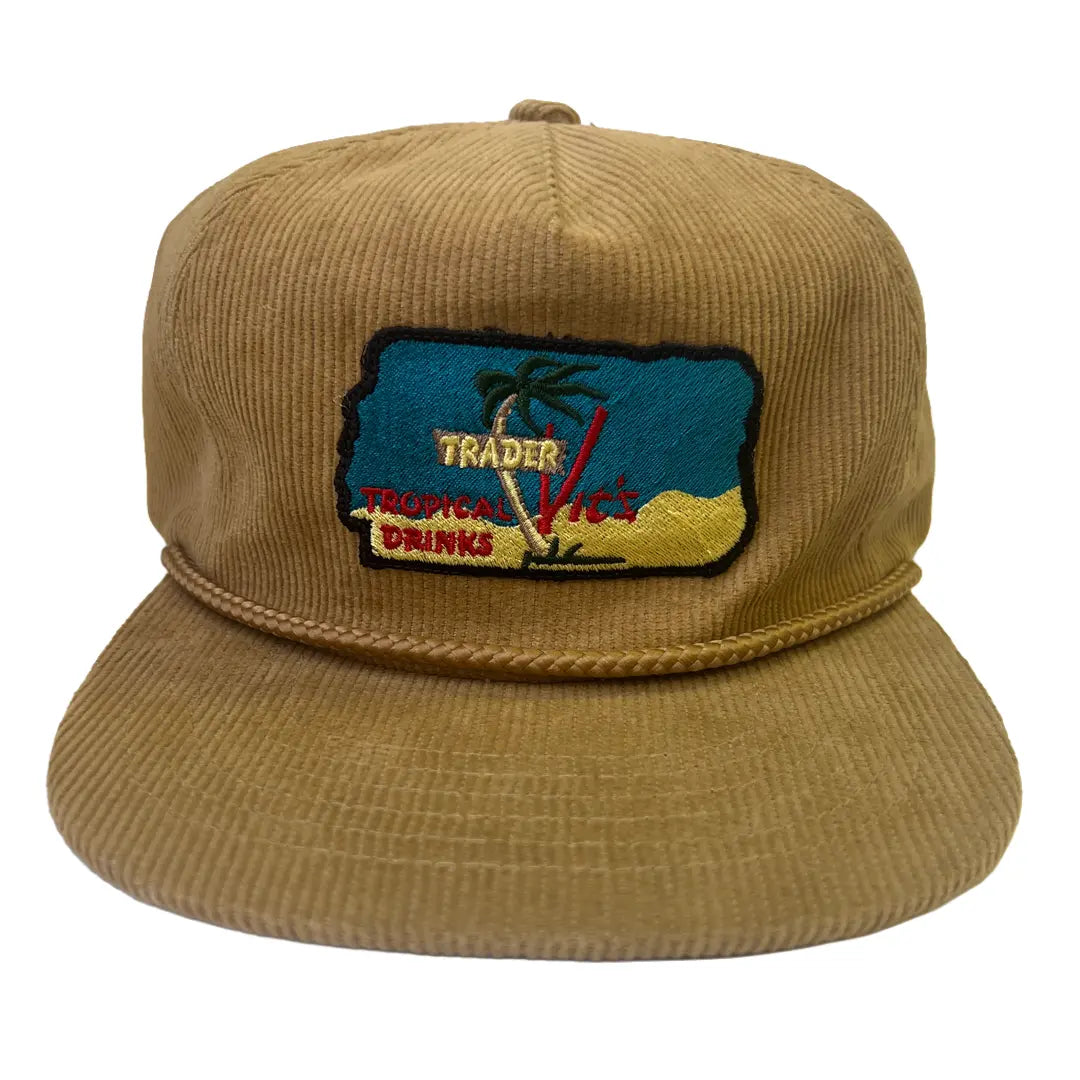 Brown corduroy cap with a embroidered patch on a white background