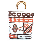 A white canvas tote bag with a brown and orange tapa pattern, featuring bamboo handle and the 'TRADER VIC'S' logo printed at the bottom.