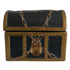 A decorative treasure chest with a dark textured finish, gold-toned trim, a padlock, and crossed chain details, shown on a plain white background.