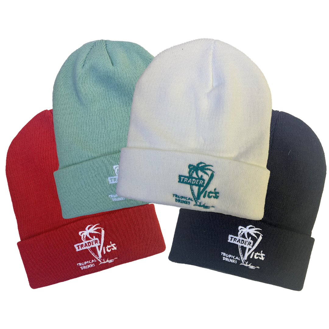Four beanies in red, green, white, and black with 'Trader Vic's' branding on a white background.