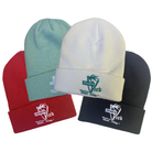 Four beanies in red, green, white, and black with 'Trader Vic's' branding on a white background.