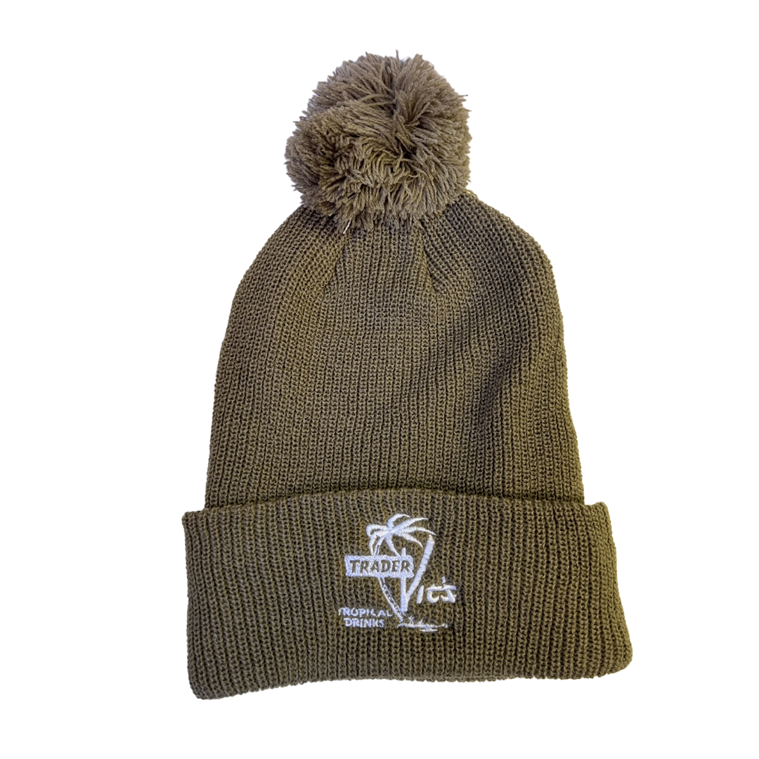 Green knit beanie with pom-pom on a white background