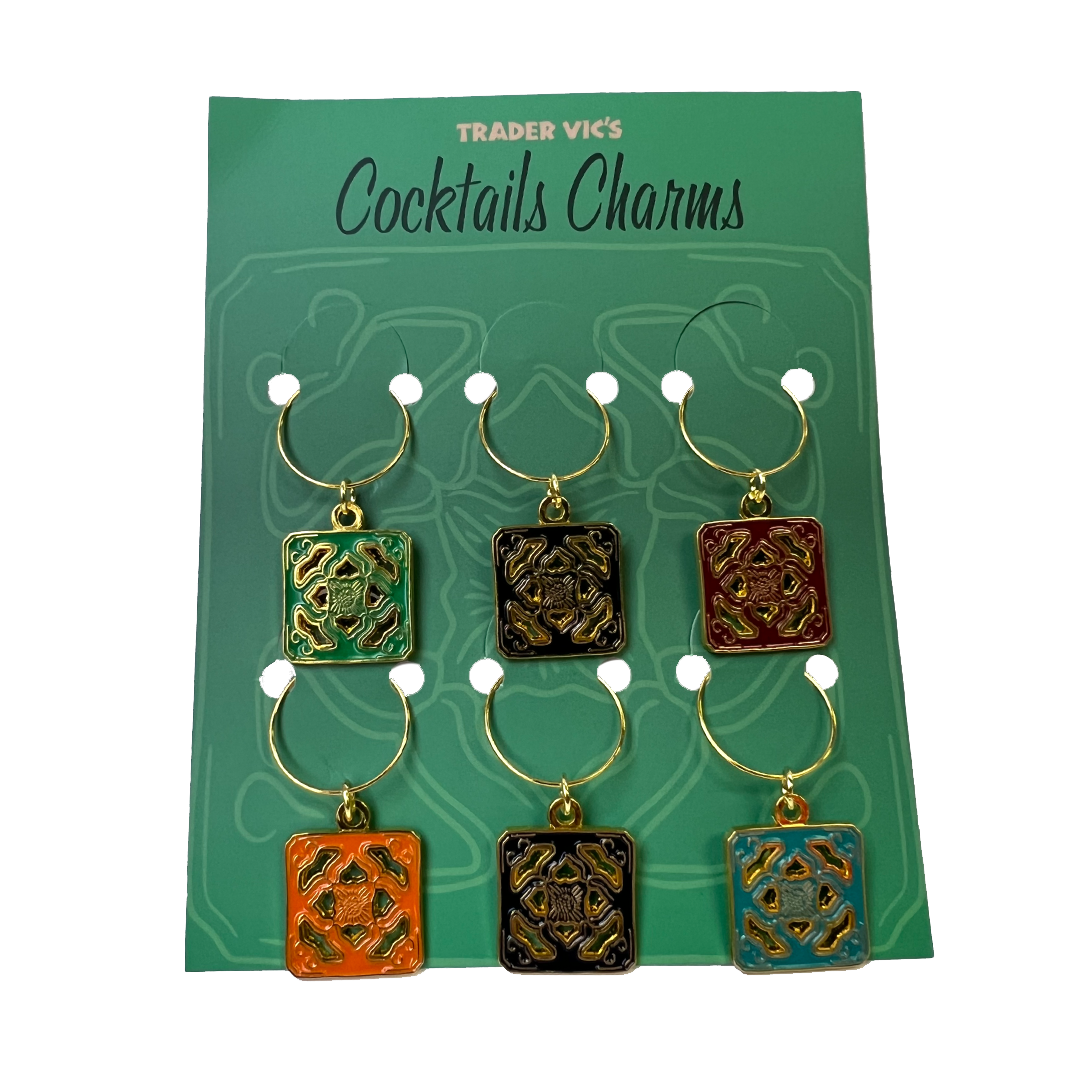 Set of six cocktail charms on a green card with 'Trader Vic's' branding.