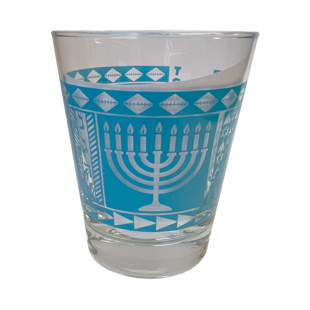 Clear glass with blue and white Menorah design on a white background