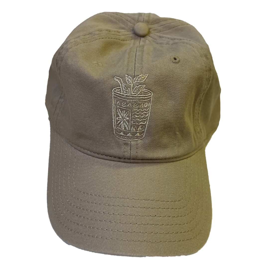 Beige cap with a plant design on a white background