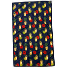 Navy blue towel with tropical pattern featuring drinks, flowers, and leaves.