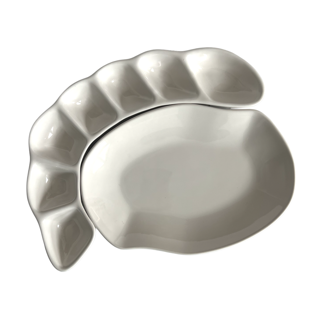 White ceramic leaf-shaped platter on a white background