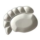 White ceramic leaf-shaped platter on a white background