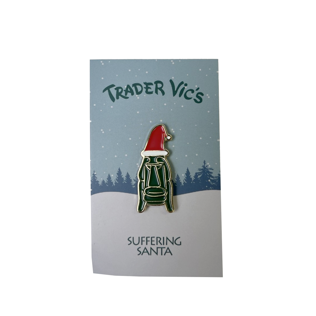 Pin with a design of a Santa-like figure on a card with 'Trader Vic's' branding.