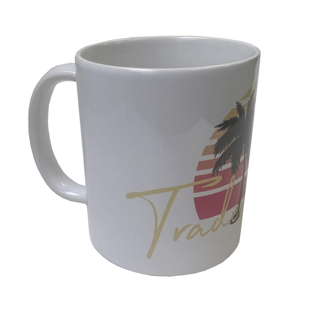 White mug with palm tree and sunset design on a white background